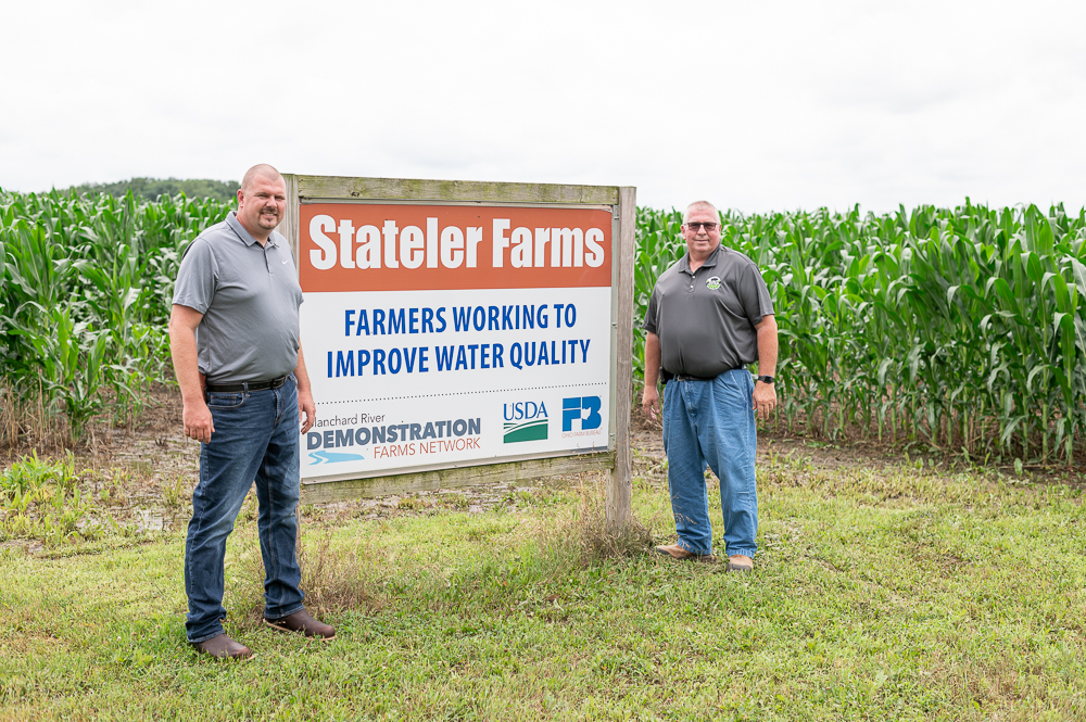 Stateler Farms farmers standing by sign